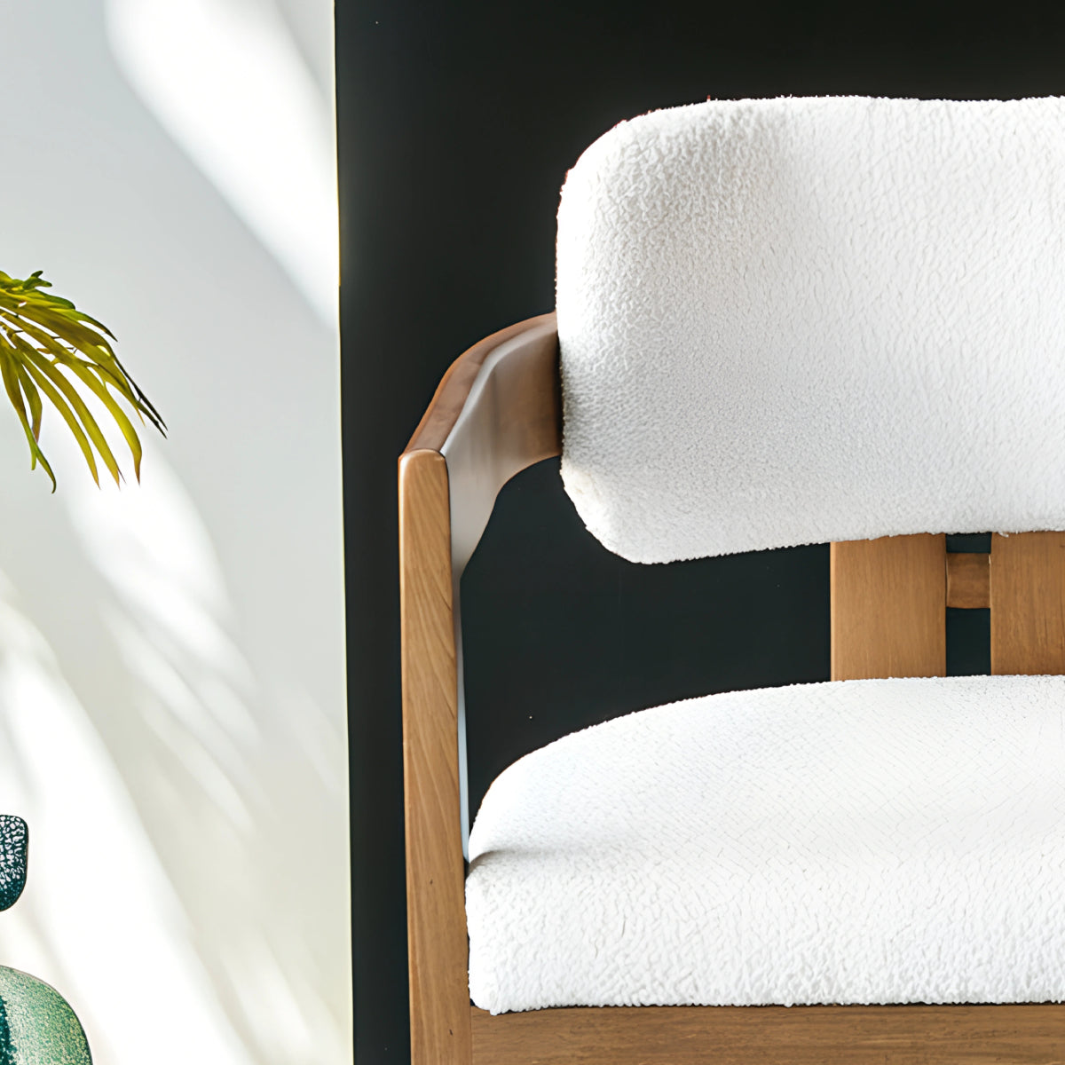 Chaise en bois avec assise en tissu bouclette, alliant chaleur naturelle et douceur texturée pour un confort enveloppant et un design élégant.